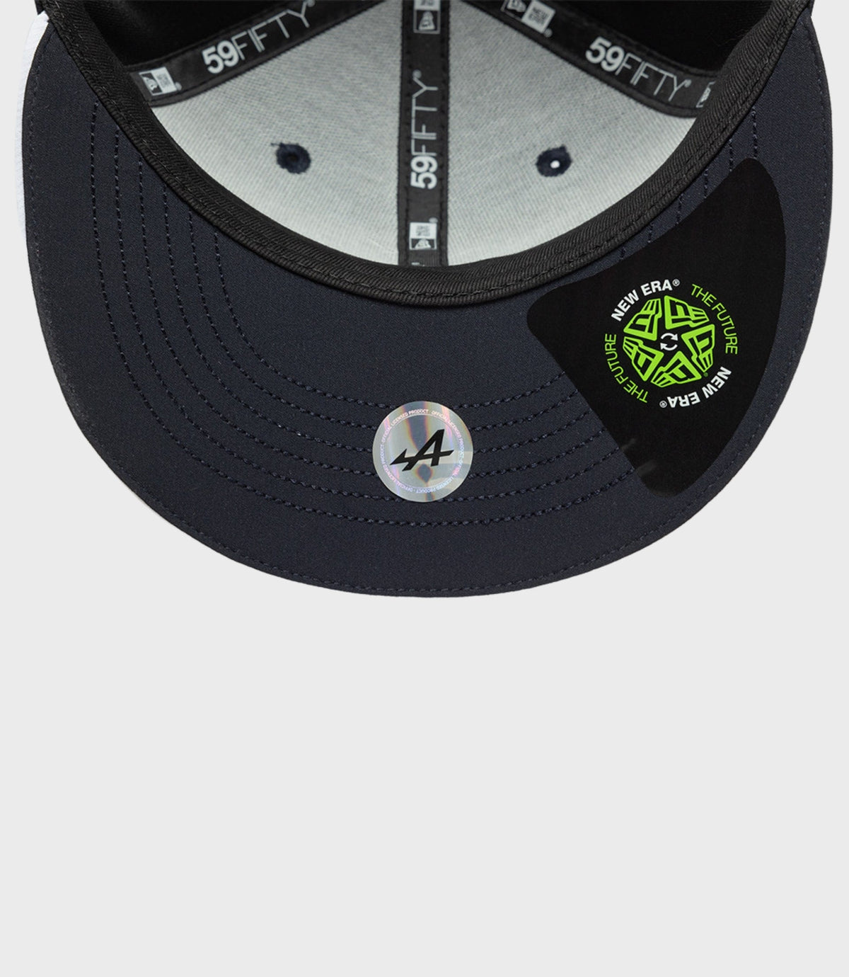 Interior close up of a navy New Era 59FIFTY cap showing 59FIFTY tape and stitched panels with recycled fabric construction