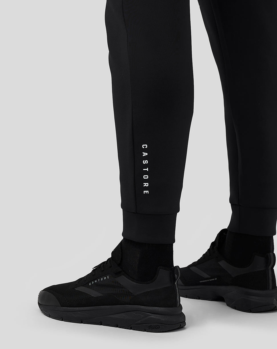 Close-up of lower leg area on black Flex Joggers with vertical CASTORE branding and cuffed ankles