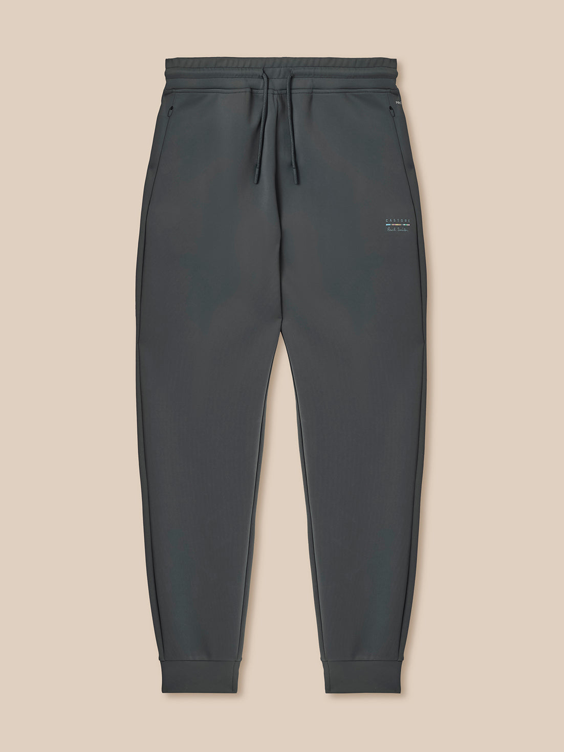 Dark gray jogger pants on a beige background