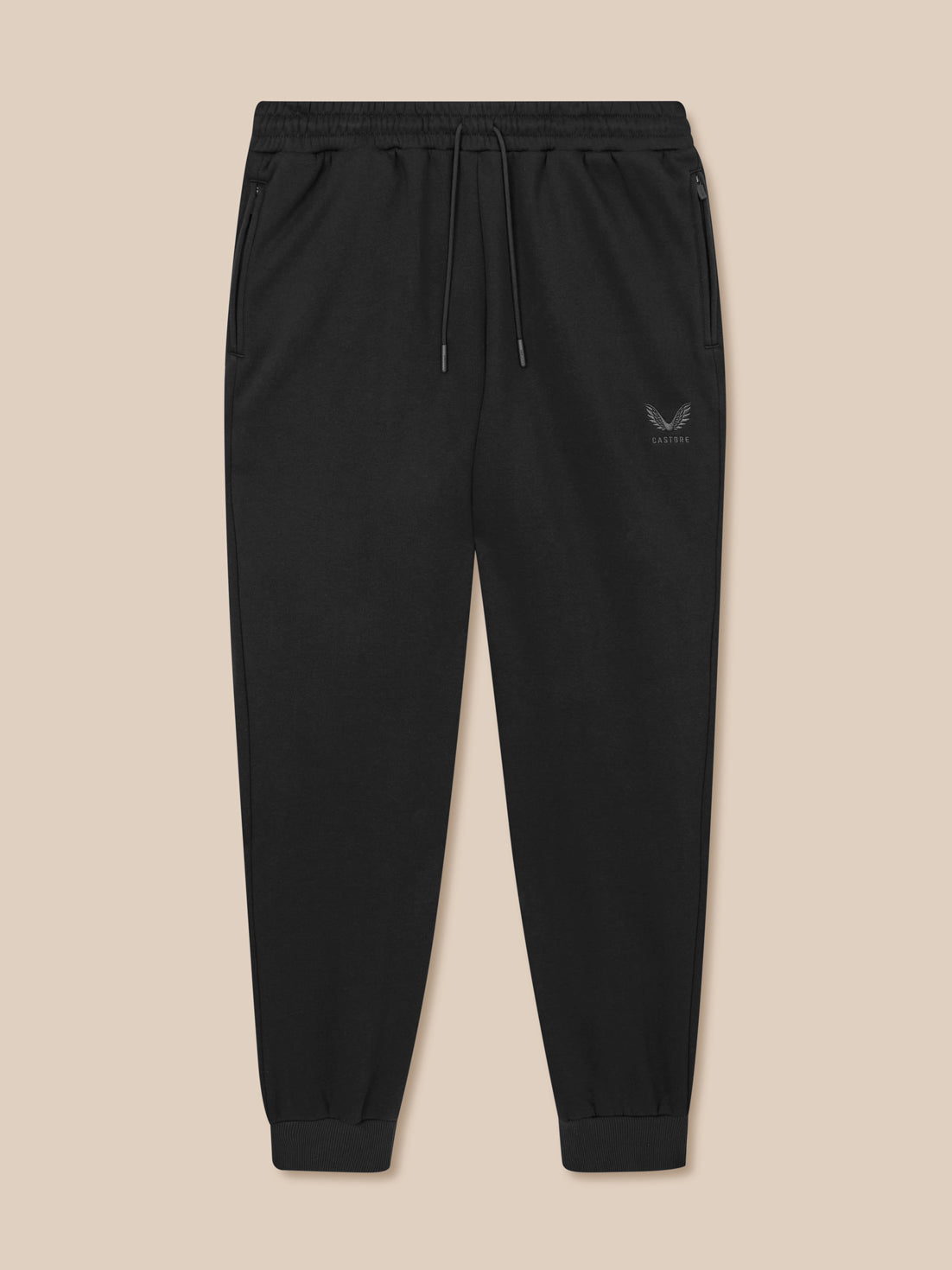 Black jogger pants with a logo on a beige background