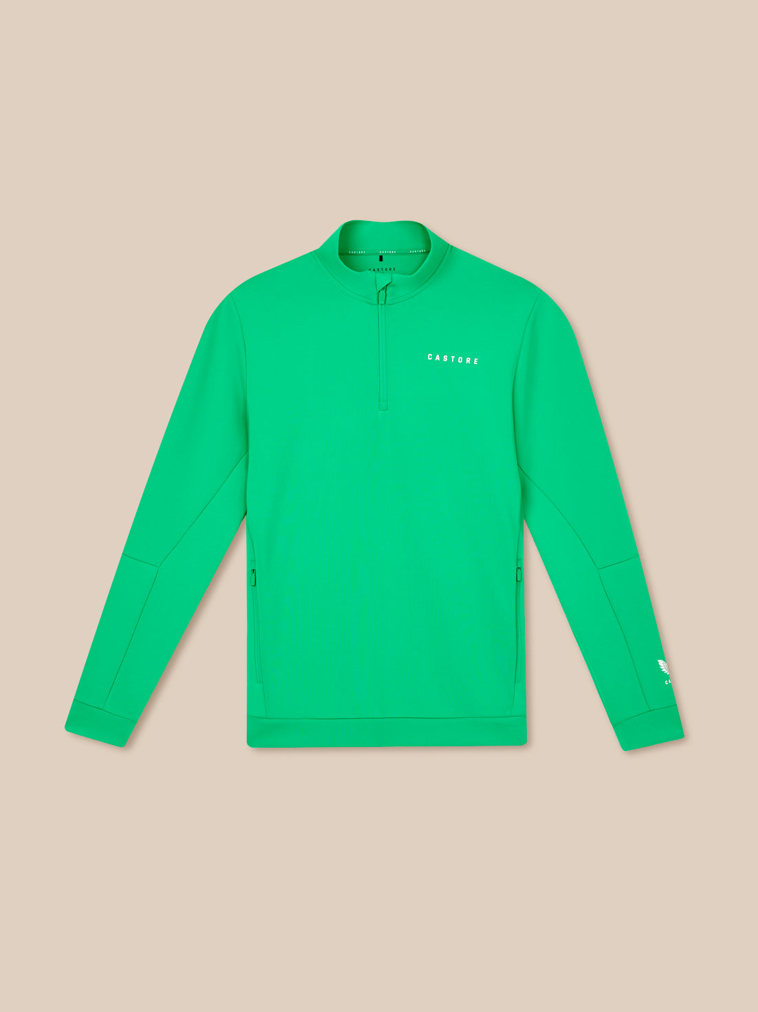 Green long-sleeve shirt with a brand logo on a beige background
