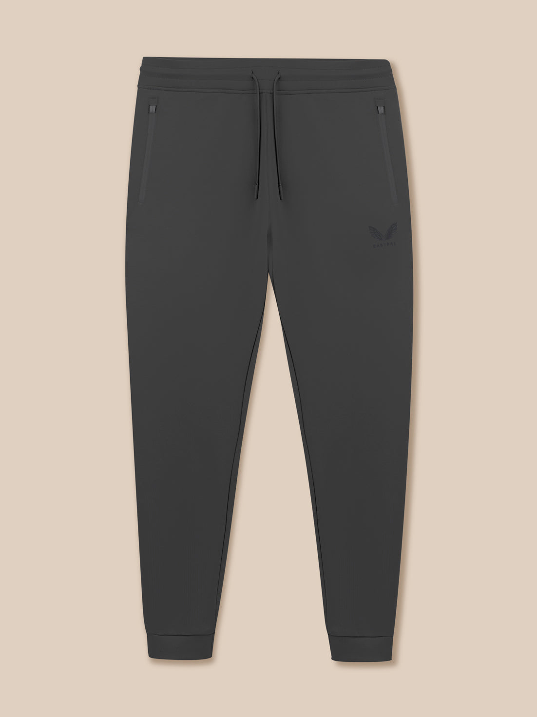 Dark gray jogger pants on a beige background