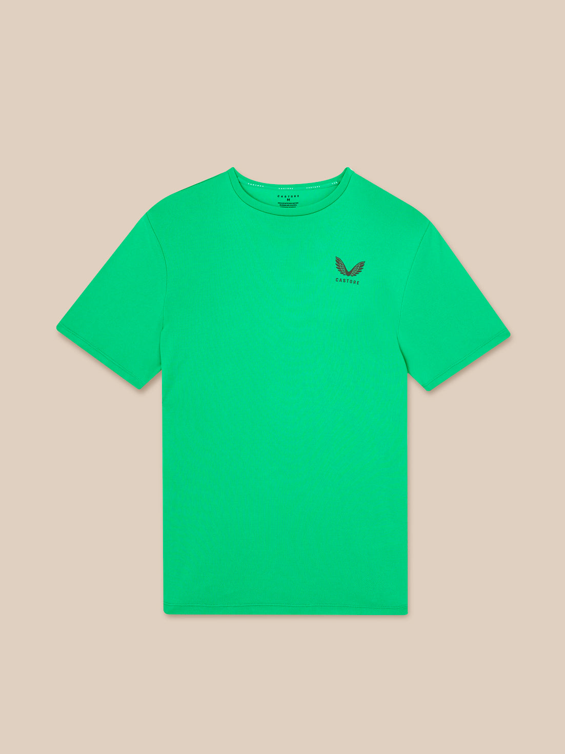 Green t-shirt with a small logo on a beige background