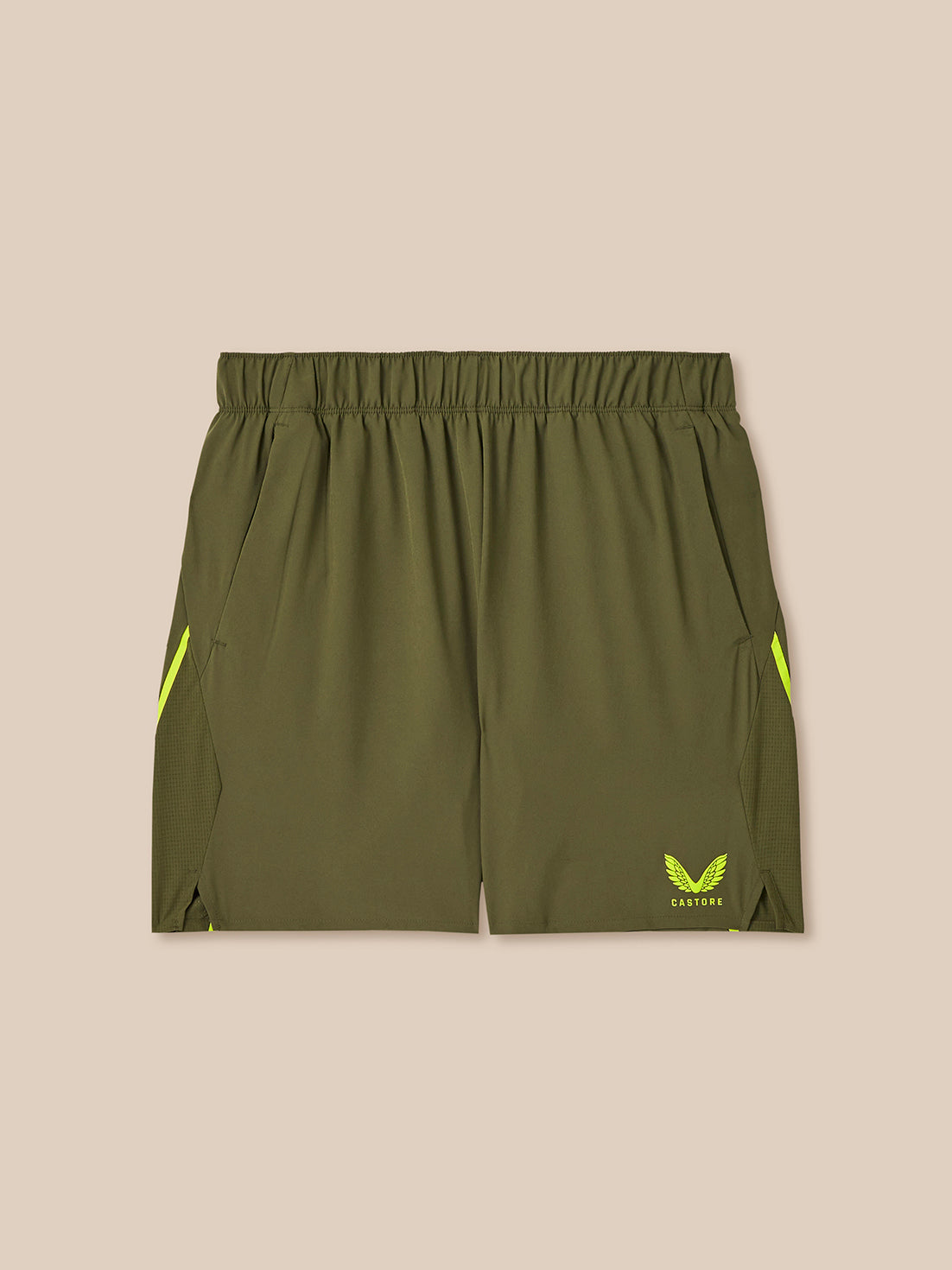Green athletic shorts with yellow accents on a beige background