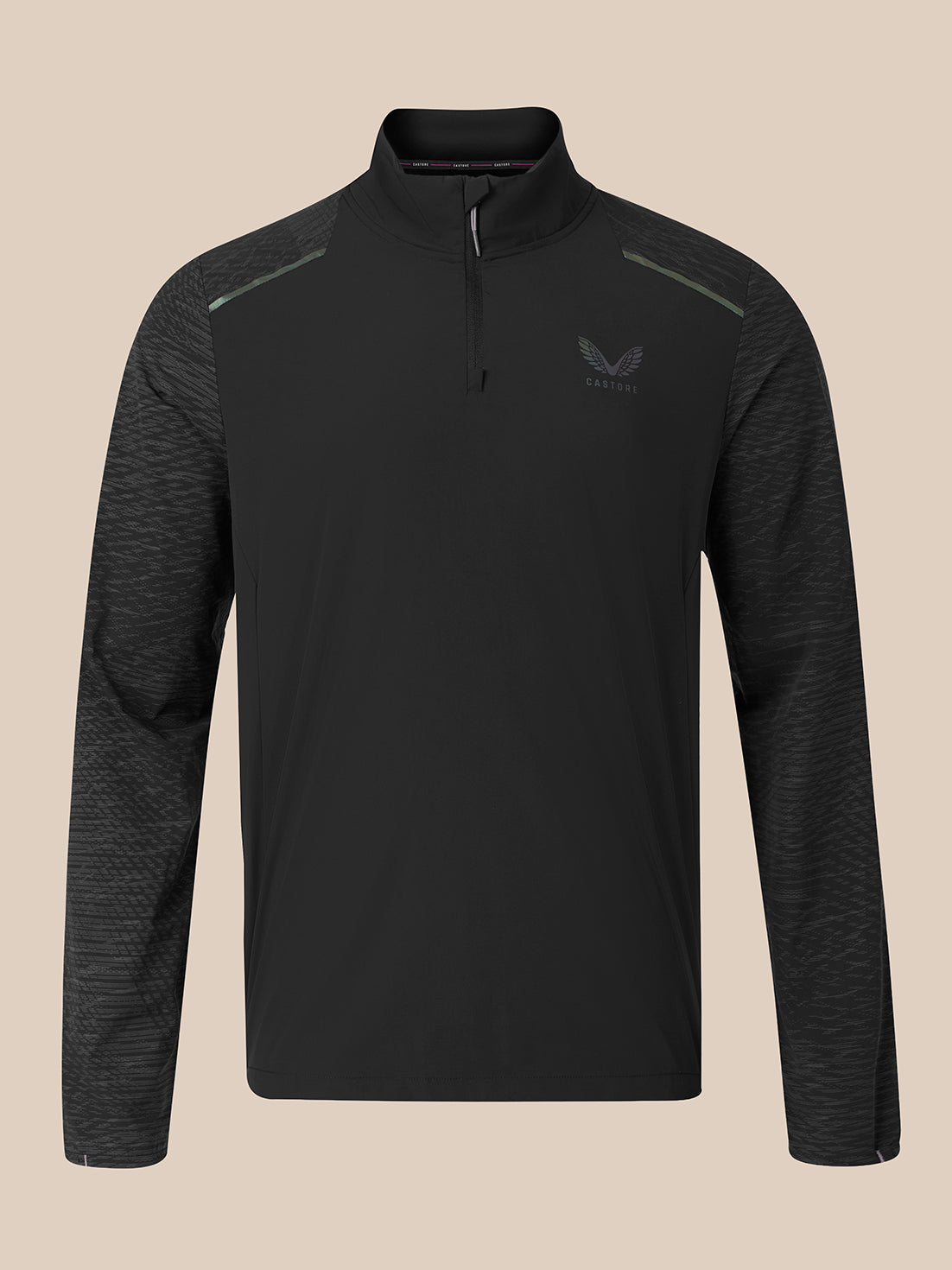 A men's long-sleeve quarter-zip athletic pullover in black, featuring a subtle textured pattern on the sleeves and shoulders, a small wing logo on the left chest, and a solid black collar, shown against a solid beige background.