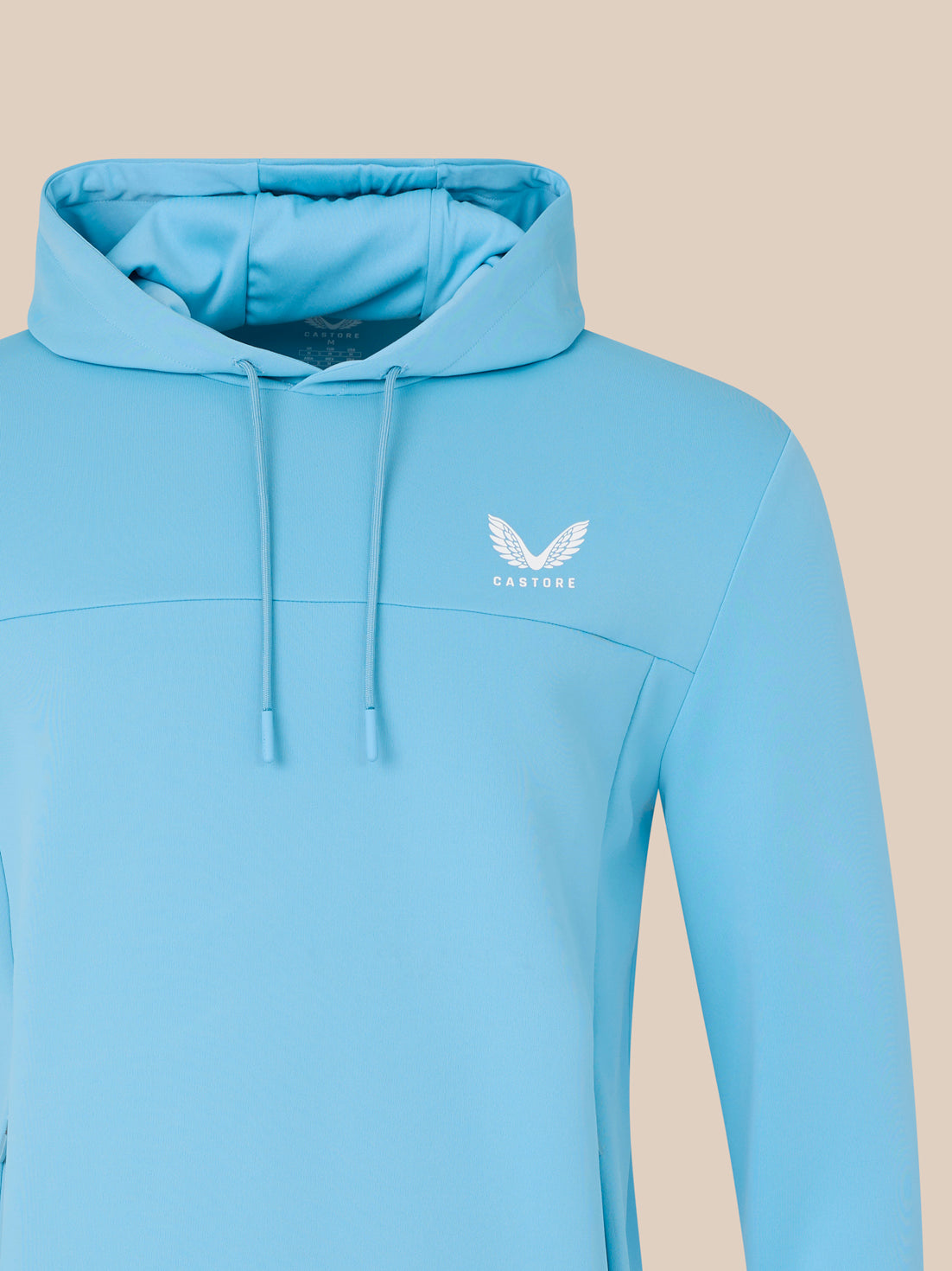Light blue hoodie with a logo on a beige background