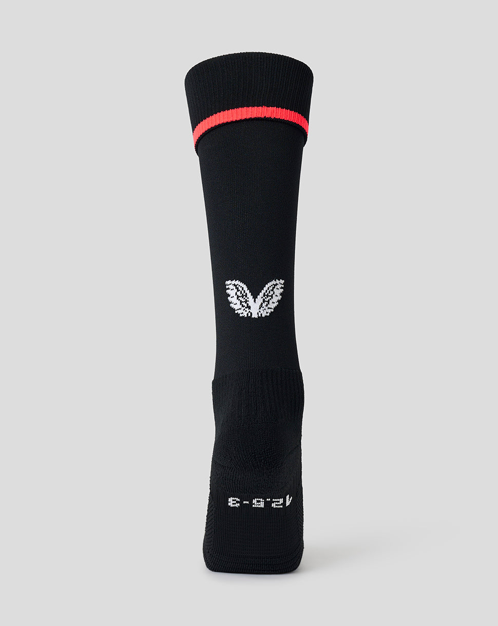 A single black athletic crew sock with a bright red band near the cuff, a white wing logo in the center, and white text near the foot, shown against a light gray background.