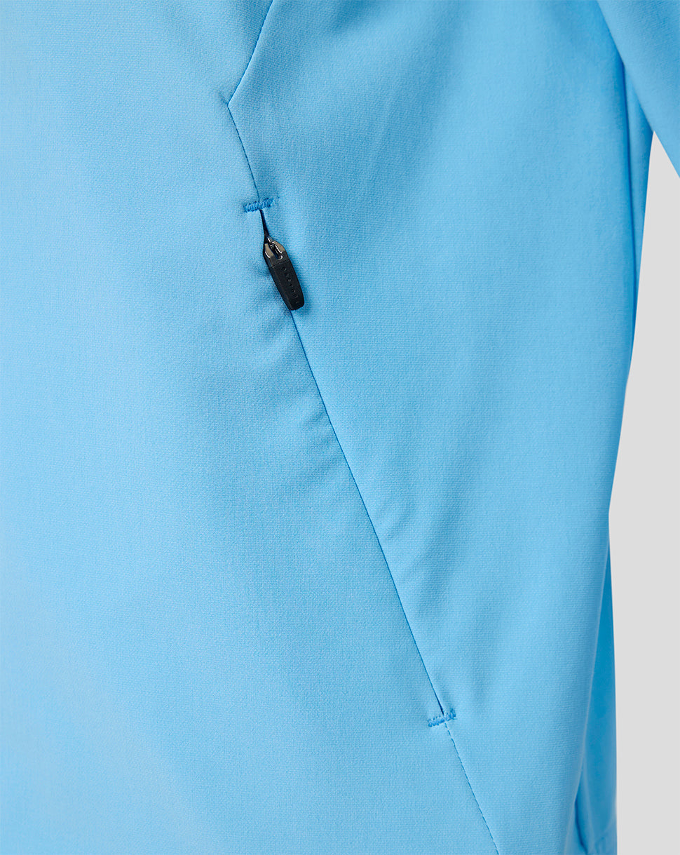 Close-up of light blue Feyenoord junior away jacket showing a zip pocket and fabric texture