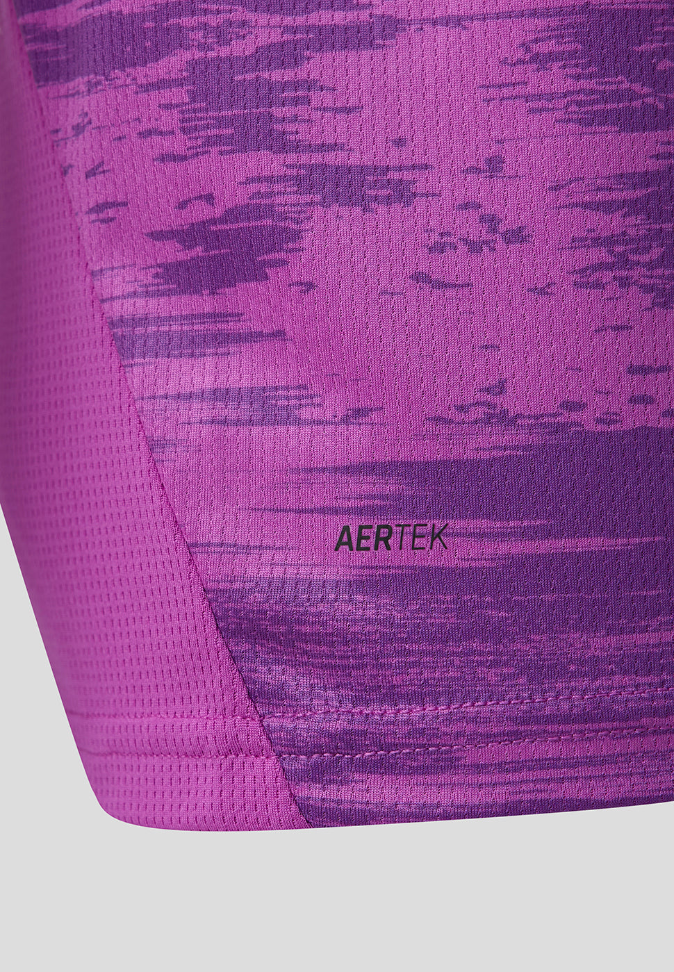 Detail of the purple patterned jersey fabric with the AERTEK label near the hem.