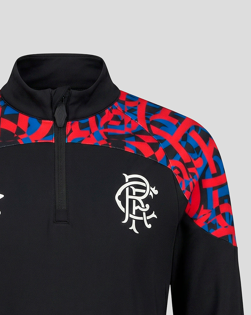 A close-up of a black quarter-zip pullover jacket featuring a red and blue abstract pattern on the shoulders and upper chest, with a white Rangers FC crest on the left chest.