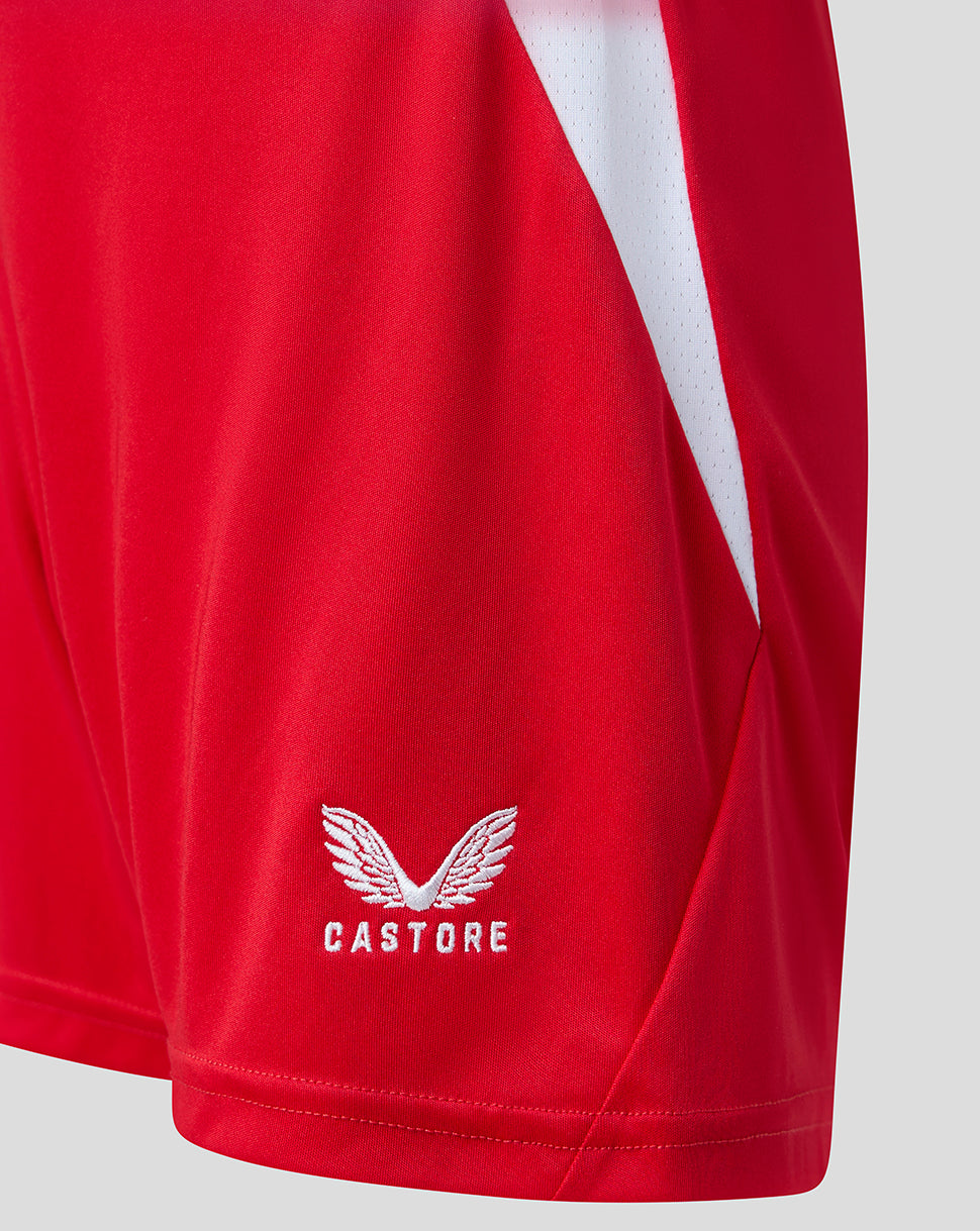 Bottom hem of red FC Twente shorts with white Castore logo.