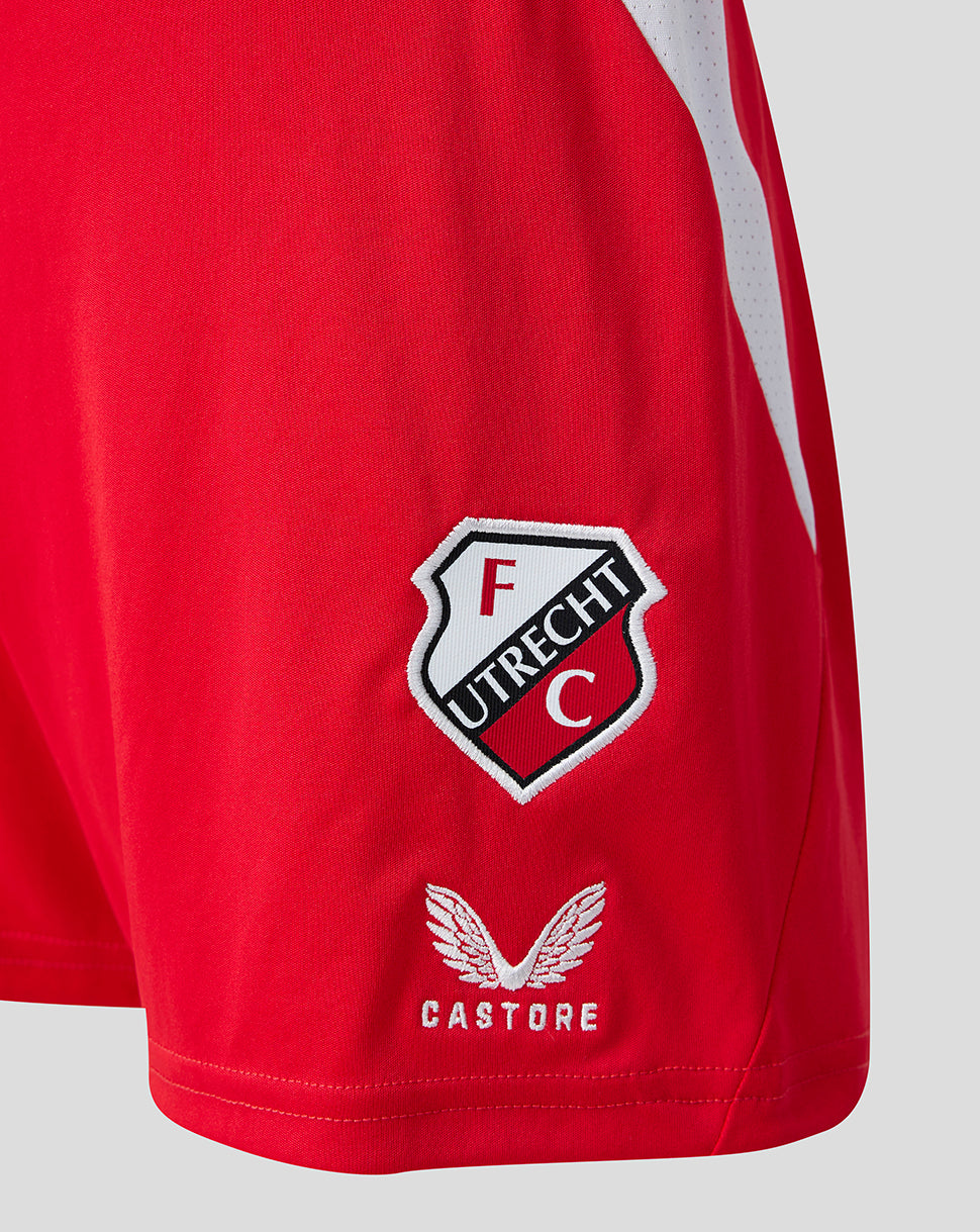 Close-up of FC Utrecht crest on red shorts with Castore emblem featuring wings