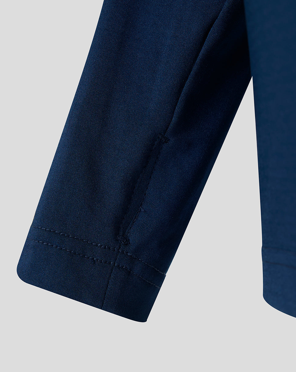 Close up of navy sleeve hem with stitching on the Athletic Club Castore midlayer.