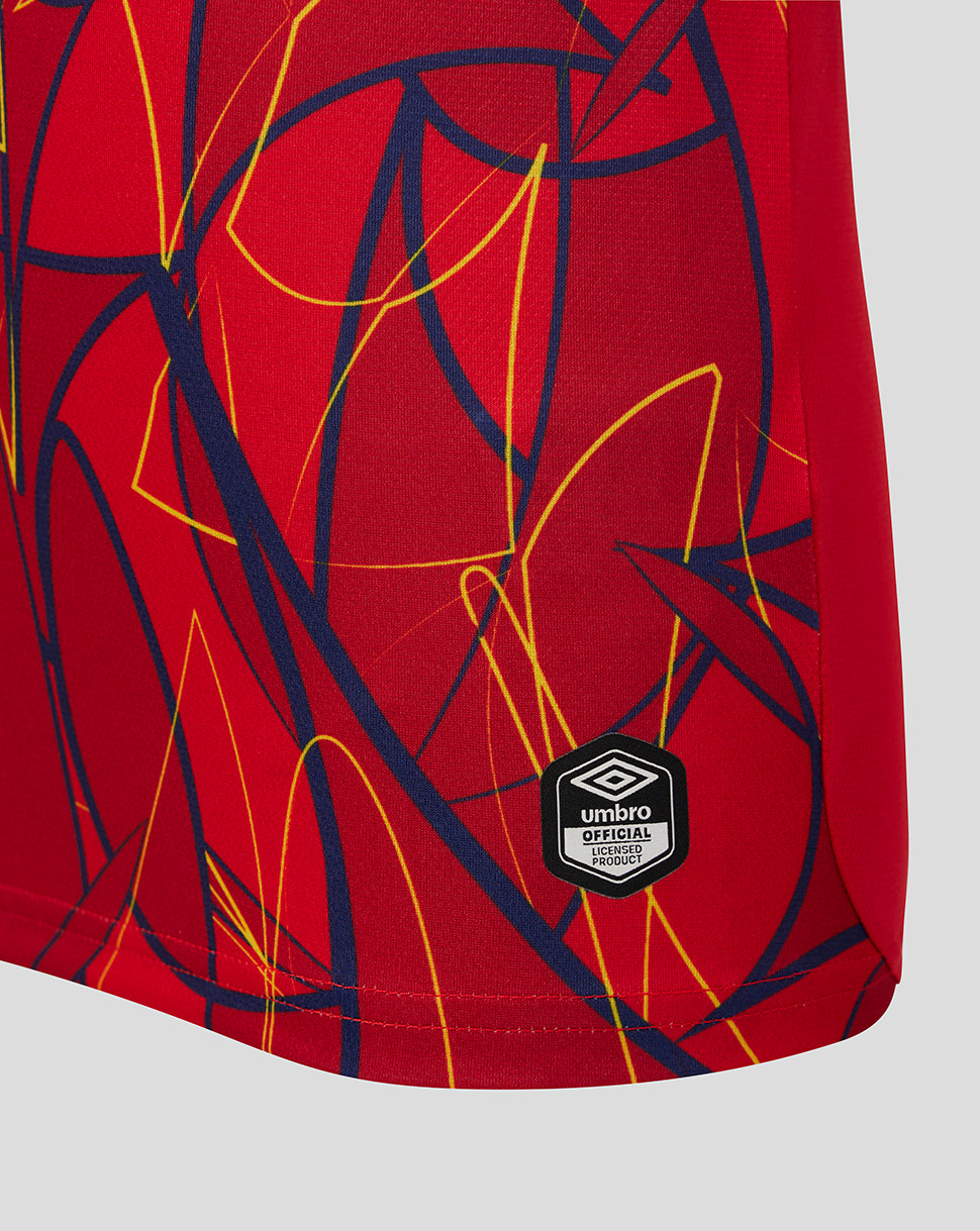 Red sports shorts with abstract pattern and Umbro logo on a gray background