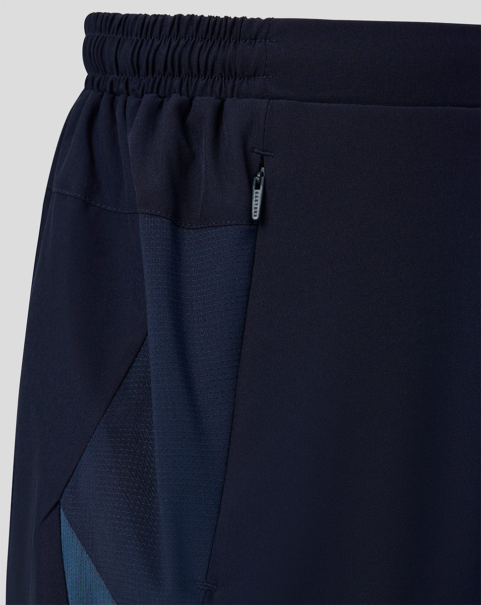 Waistband and side zip pocket detail on navy training shorts.