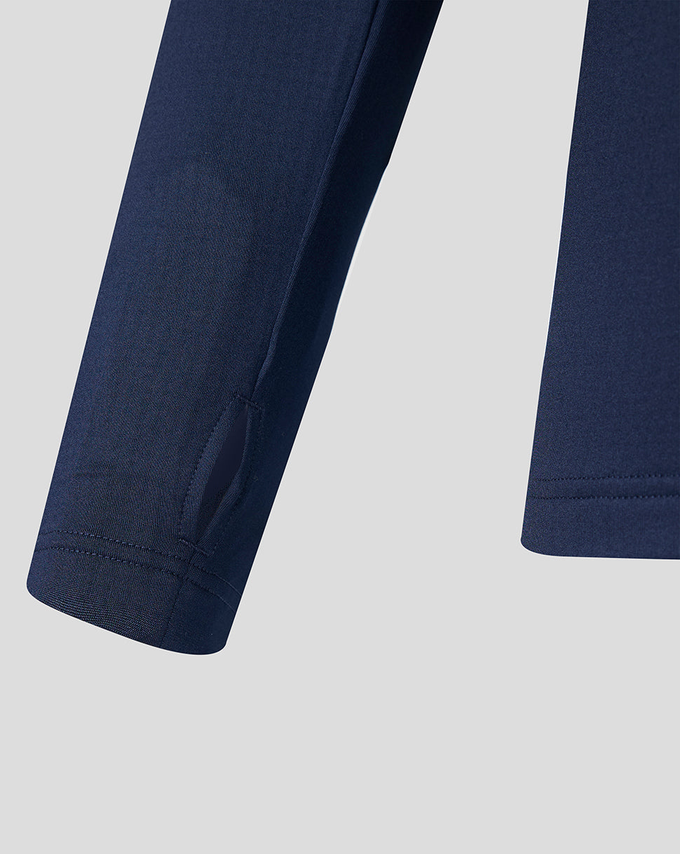 Close up of navy sleeve with neat stitching and a curved hem detail.