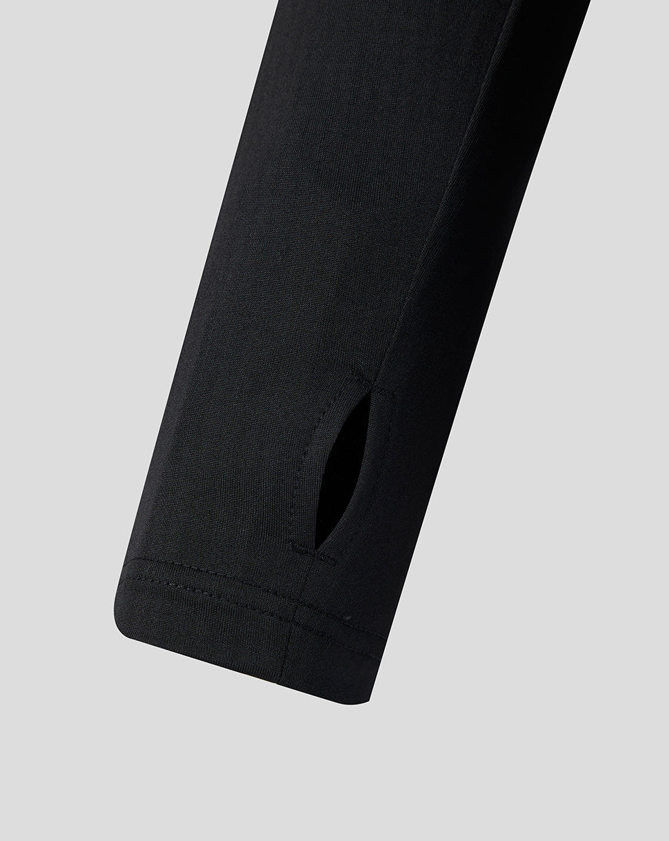 Close up of the black long sleeve cuff with a small slit at the wrist.