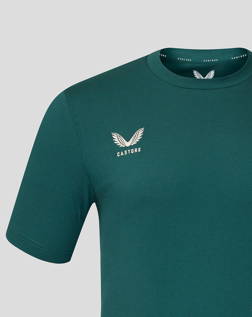 Close up of teal Athletic Club Junior travel shirt showing left chest crest and shoulder seam