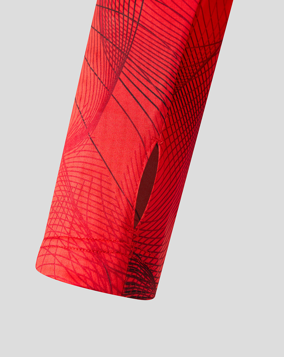 Close-up of Feyenoord red midlayer fabric with diagonal lines and a vent slit.