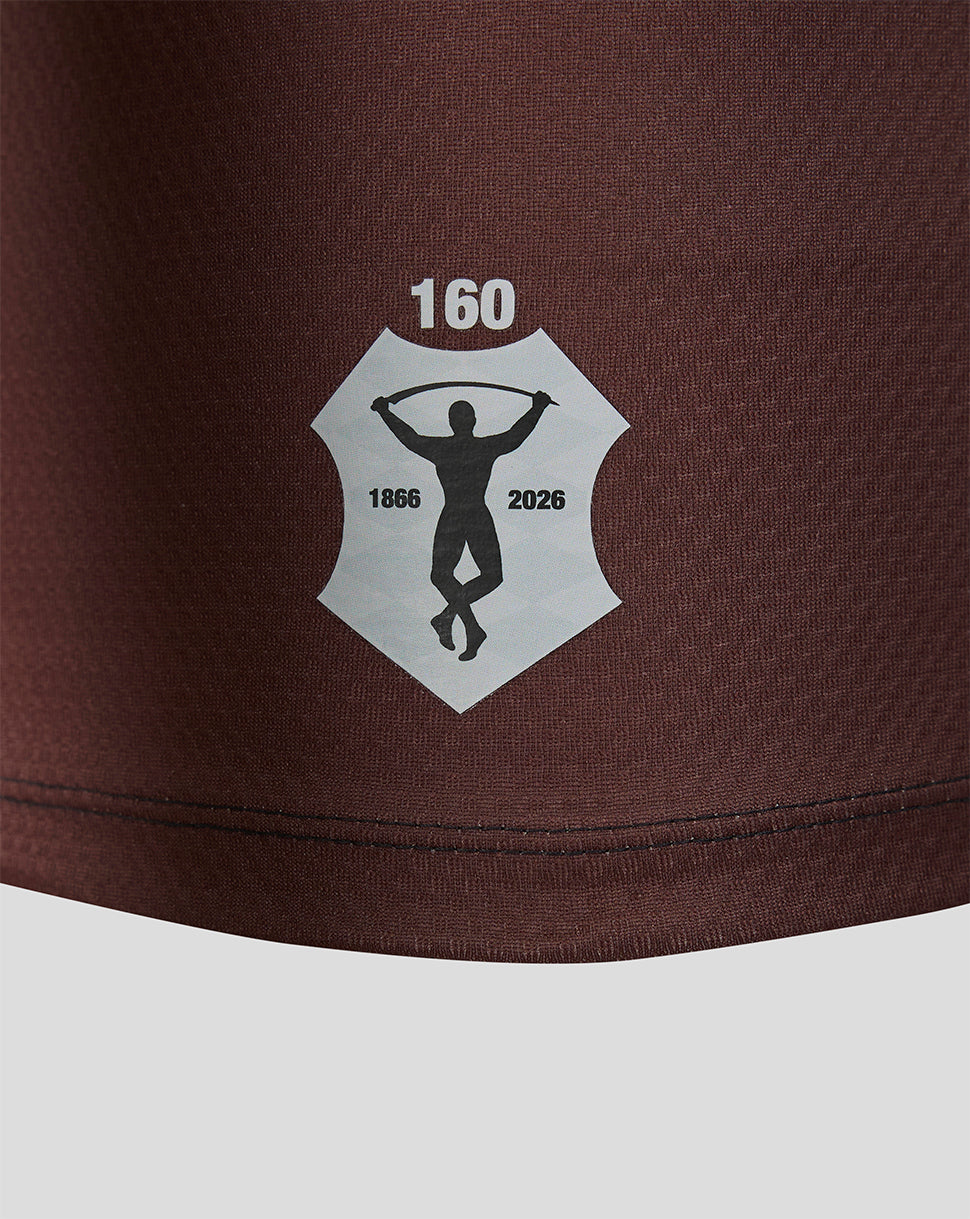 Brown shorts with a logo featuring a silhouette and text on a white background