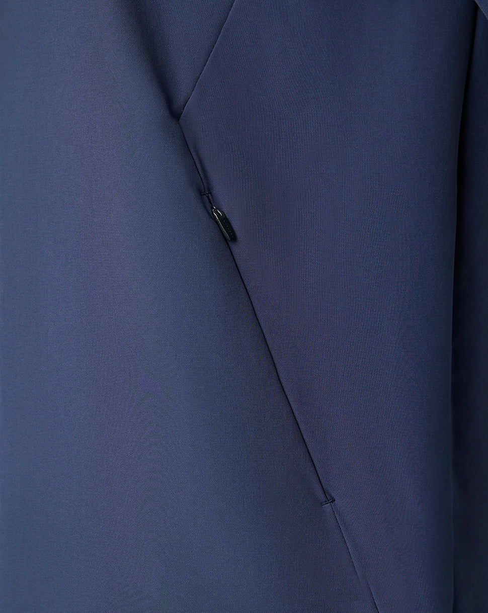 Close-up of navy Feyenoord jacket fabric with diagonal seam and small zip pocket pull