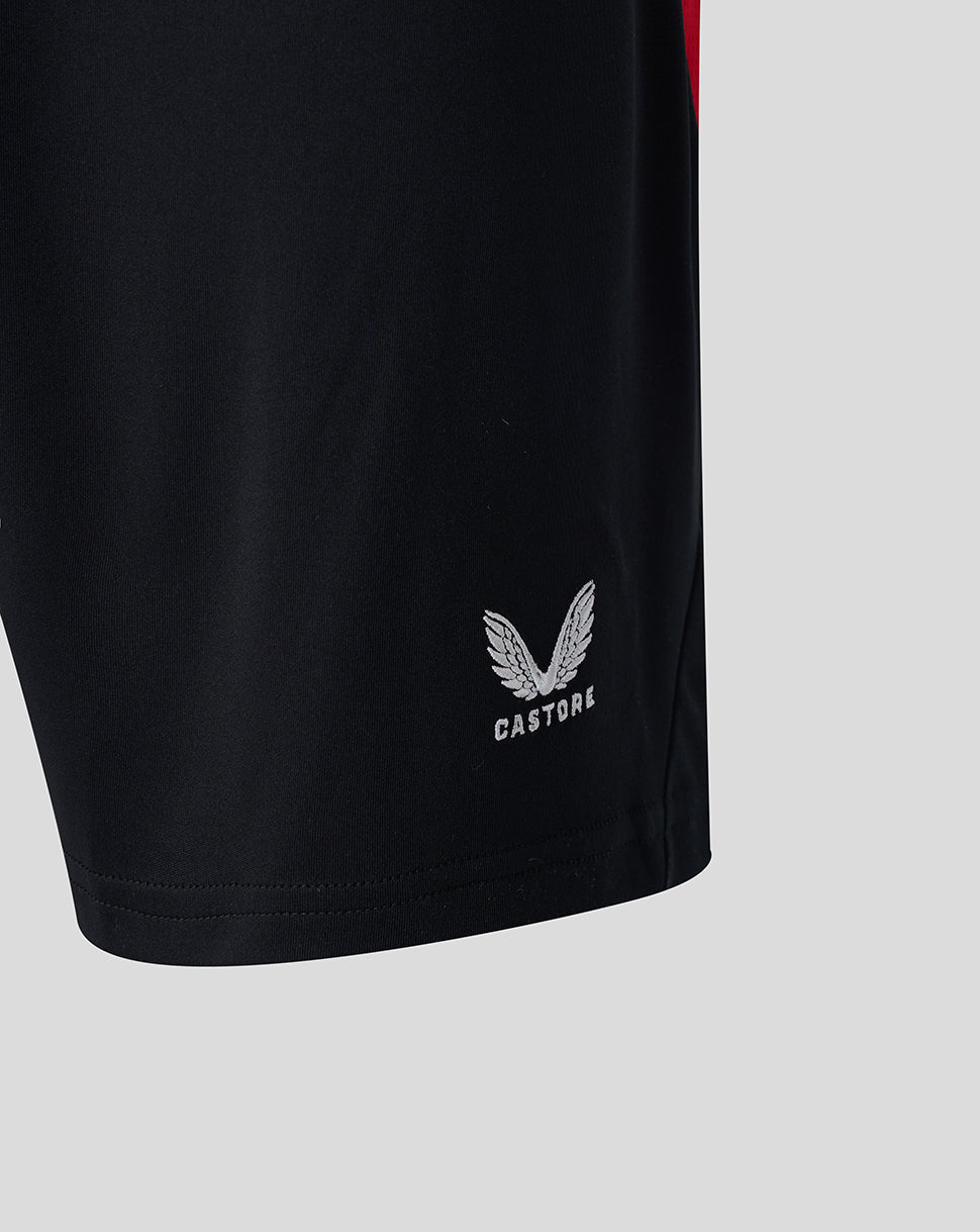 Close up of black athletic shorts with a white Castore logo near the hem.