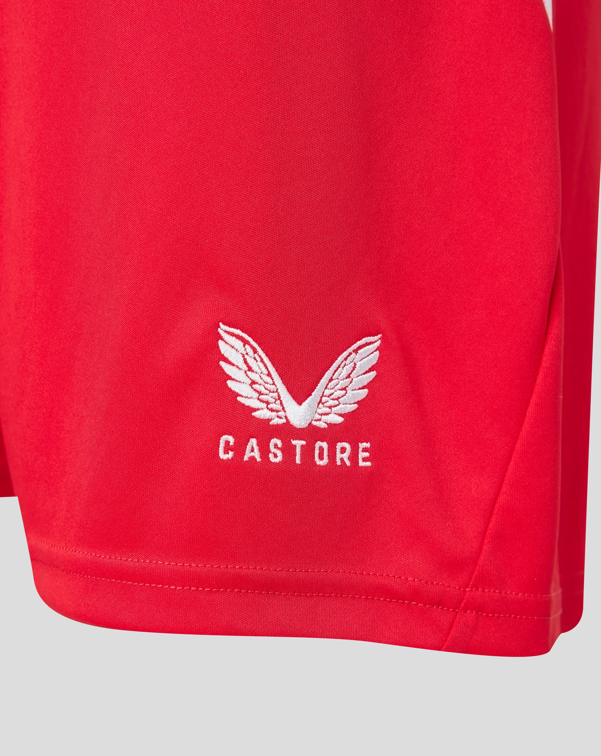 Red FC Twente shorts close up with club crest on the leg and Castore logo.