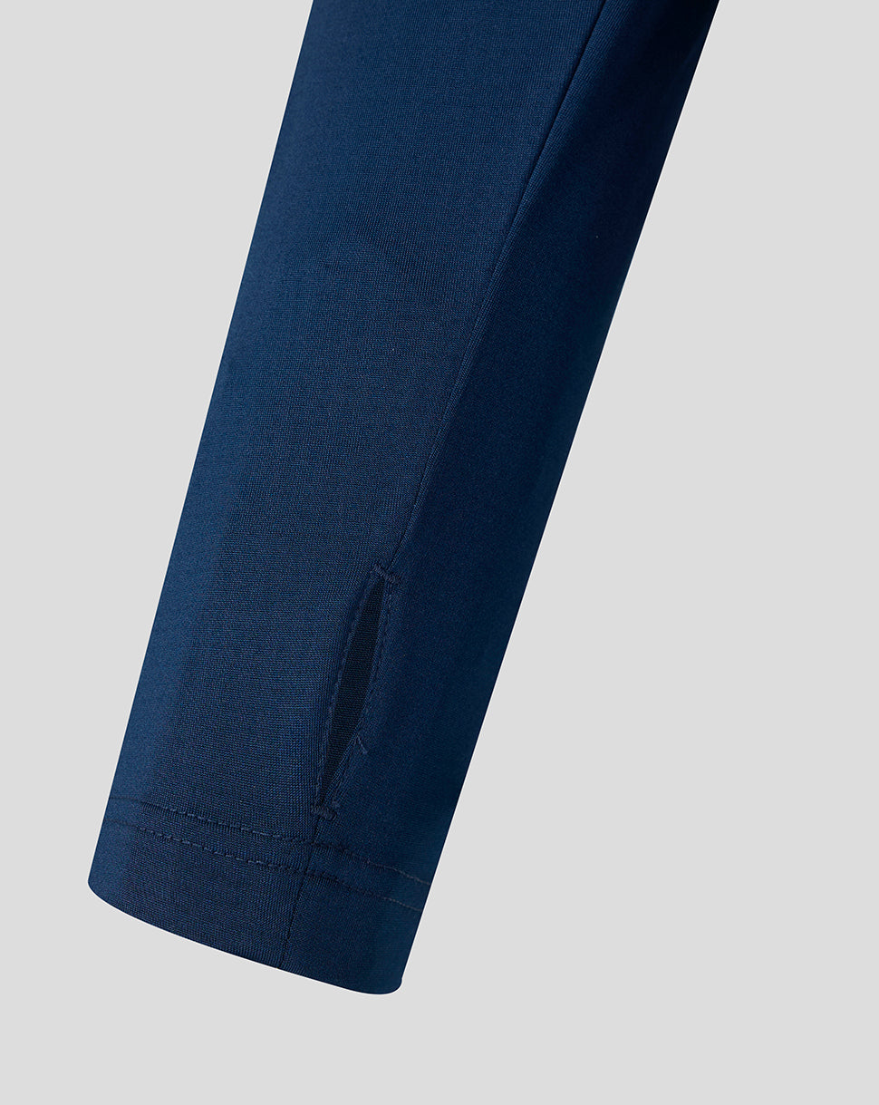Close up of navy sleeve showing a small vent near the cuff.