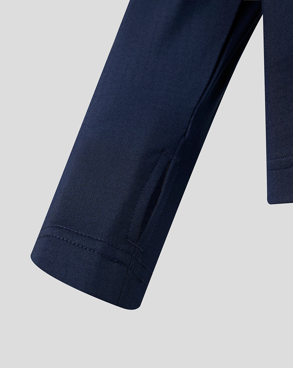 Close-up of navy Athletic Club women's training midlayer sleeve with a small zip pocket.