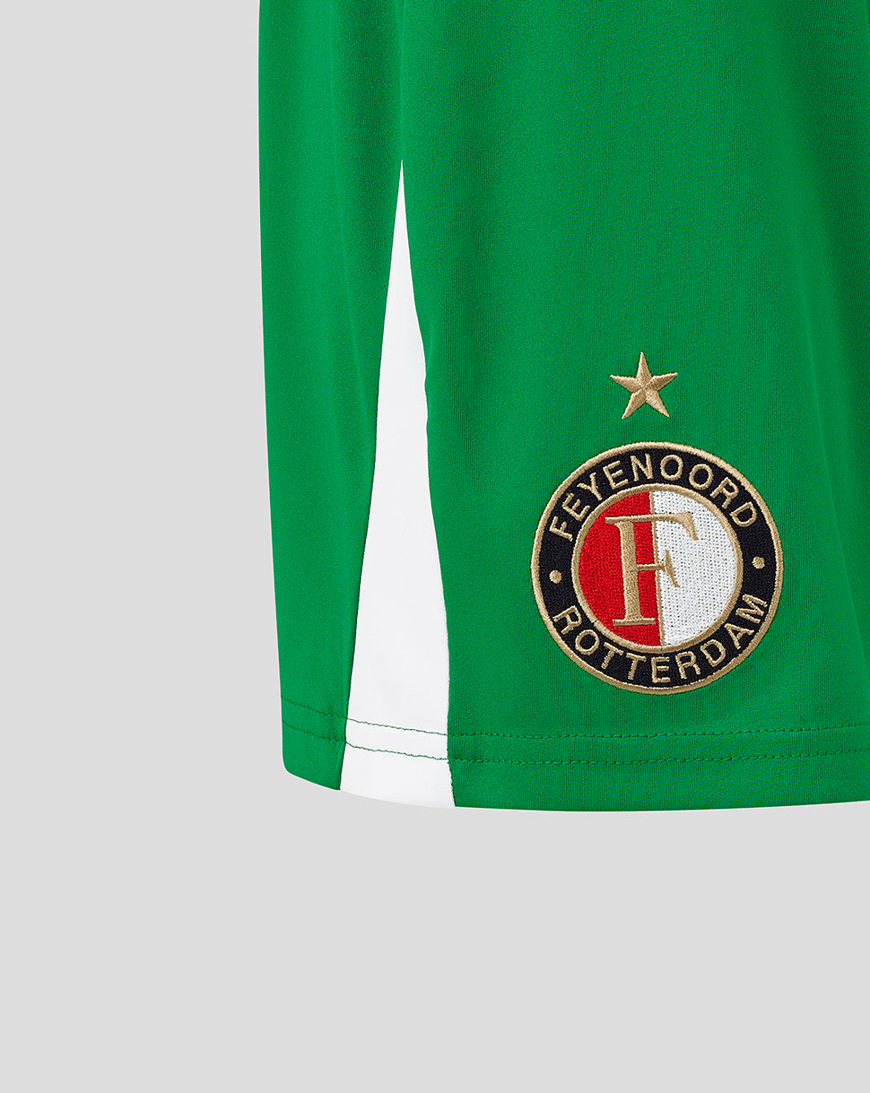 Close up of green shorts showing embroidered Feyenoord crest on the left leg with white hem trim.