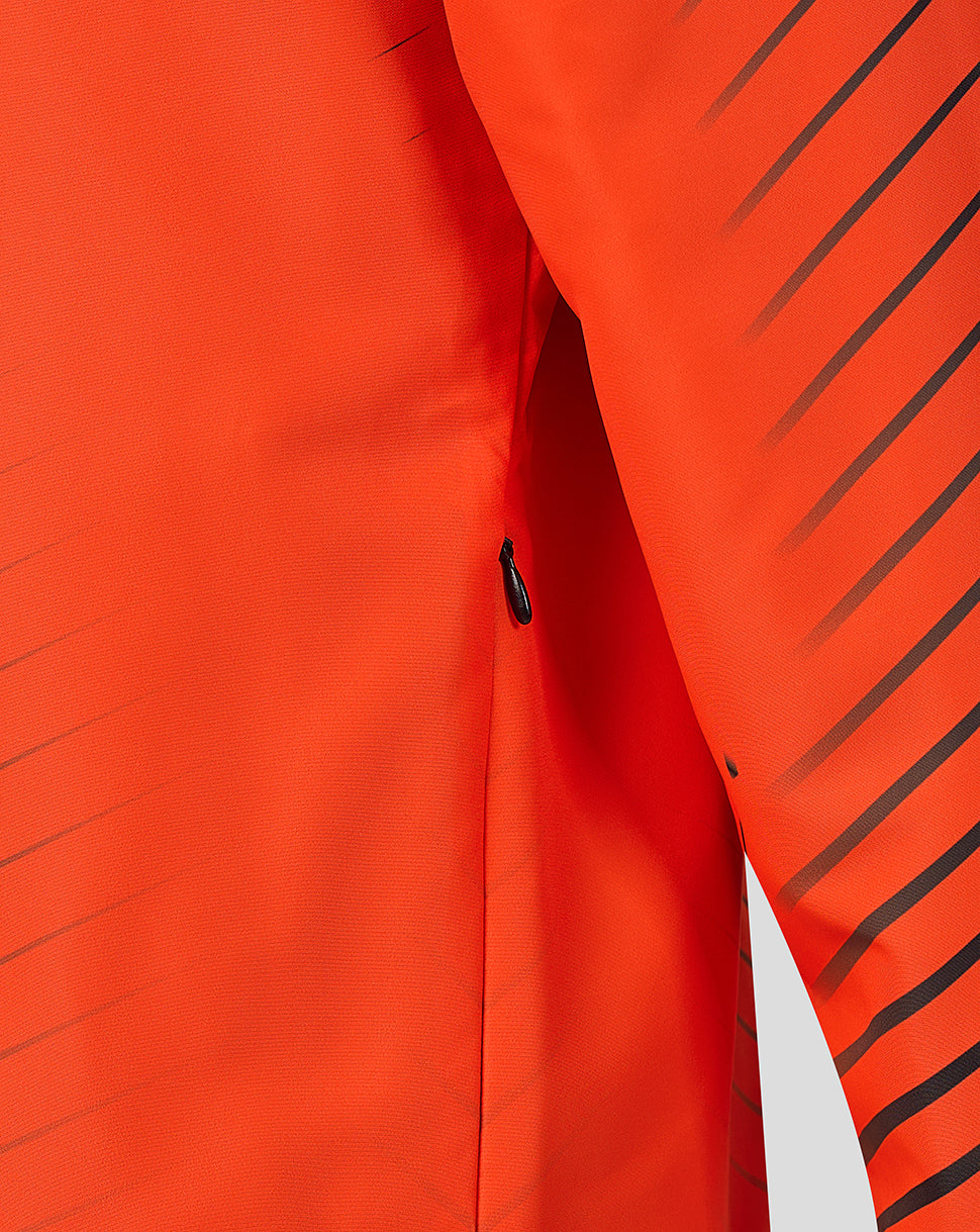 Detail of side zip pocket on bright orange jacket with diagonal stripes.