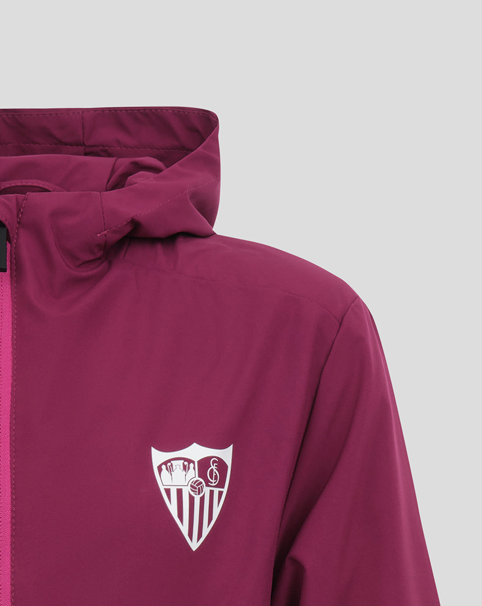 Sevilla Junior Training Lightweight Purple Jacket with club crest on the chest and pink zipper detail.