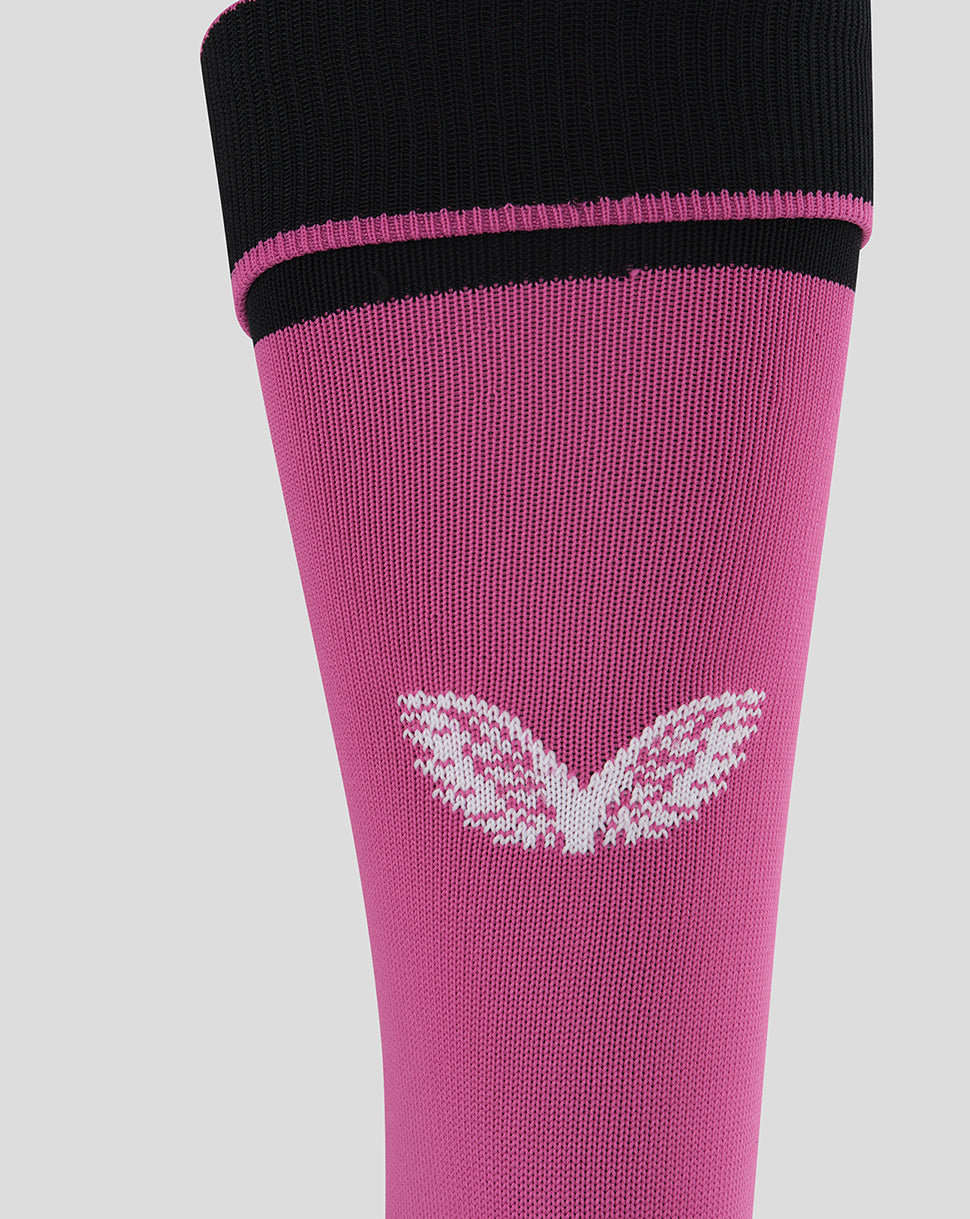 A close-up of a pink knit sock with a black ribbed cuff, a thin pink stripe, and a white butterfly graphic on the front, set against a solid light gray background.