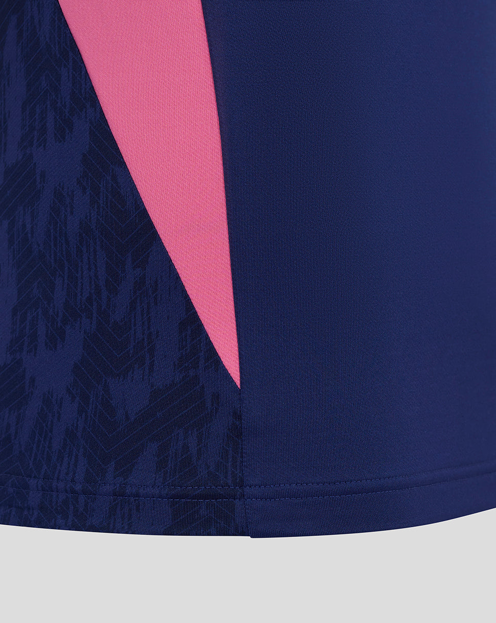 Close-up of Feyenoord training midlayer fabric with navy base and a pink angled side panel.