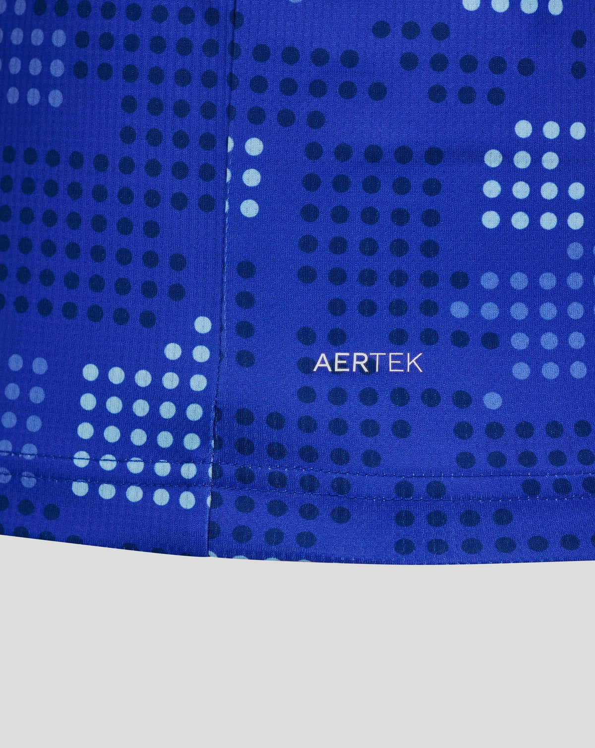Close-up of a blue athletic garment with a geometric dotted pattern and the AERTEK logo printed in white near the center.