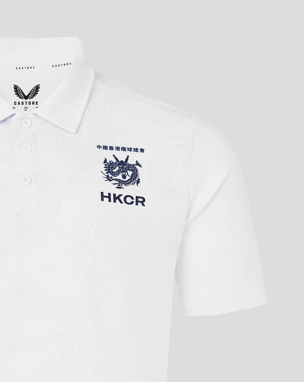 White polo shirt with embroidered logo and text on a light gray background