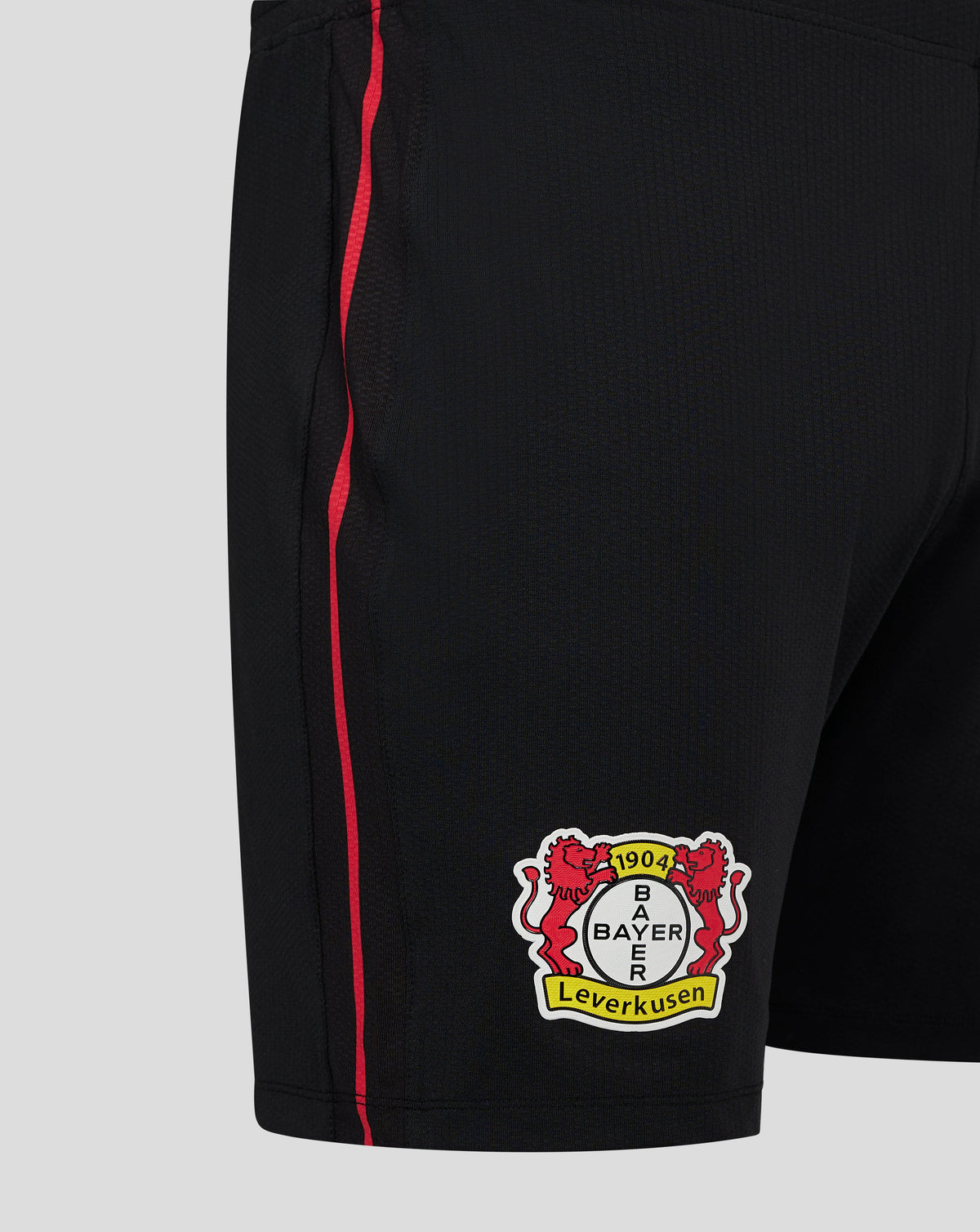 Close up of black Bayer Leverkusen Pro shorts showing a red side stripe and Bayer club crest