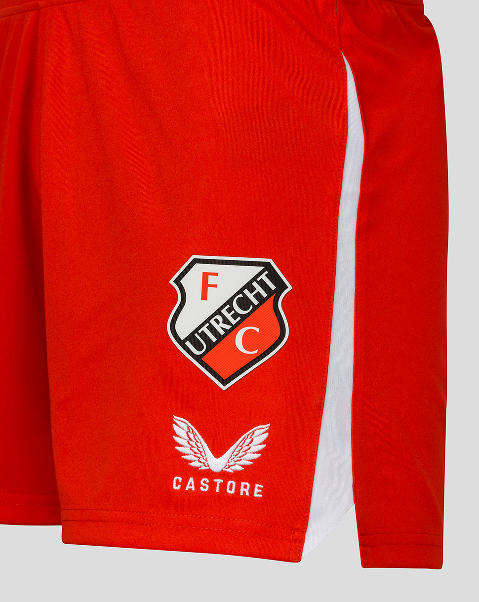 Close up of FC Utrecht crest and Castore logo on red shorts with white trim.