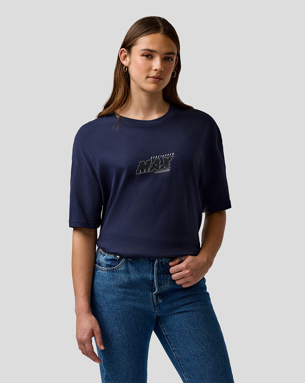 Person wearing a navy blue t-shirt with text and jeans on a light gray background