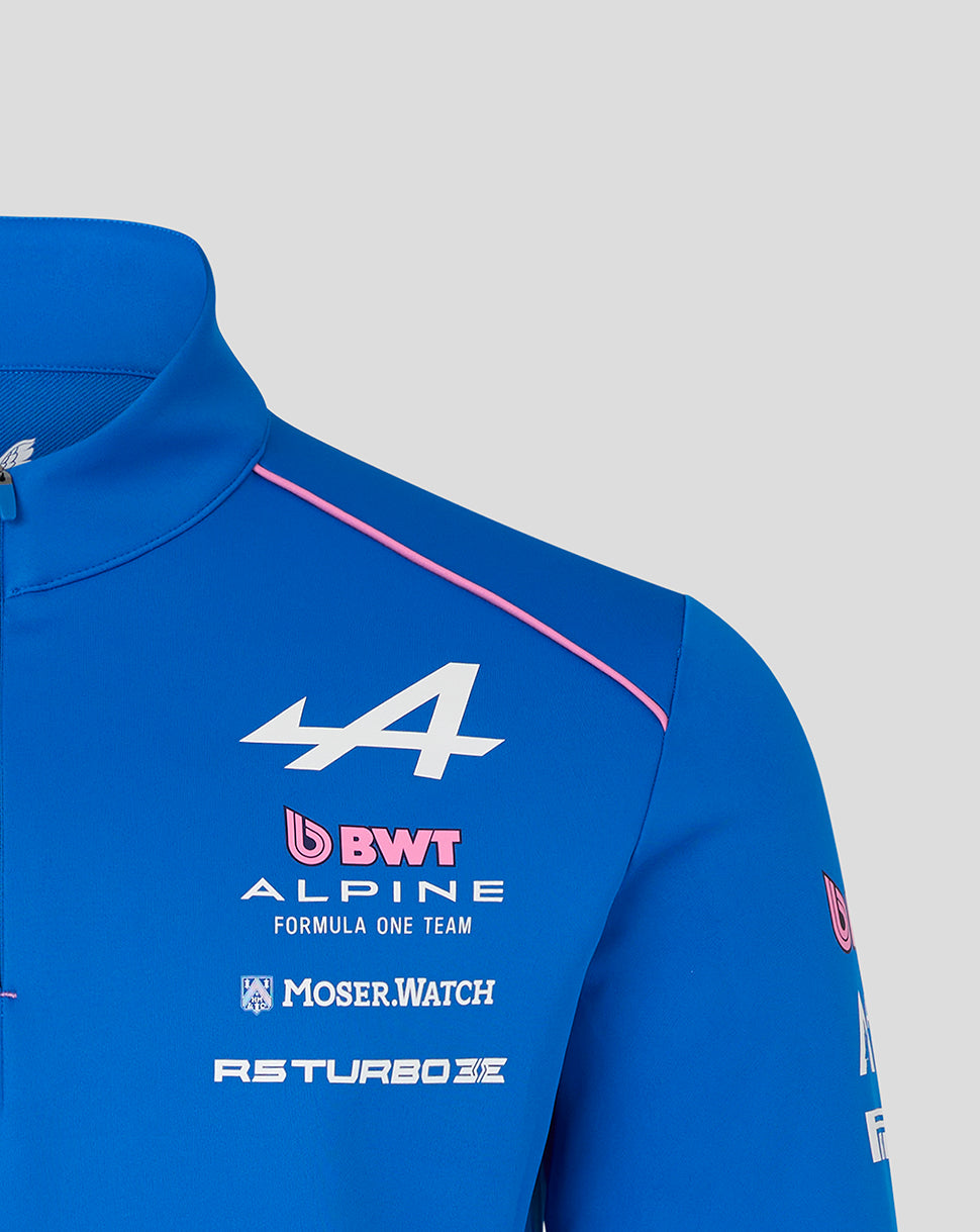 Close up of blue Official Unisex BWT Alpine Formula One Team Quarter Zip Midlayer with pink piping along the shoulder and chest sponsor logos.
