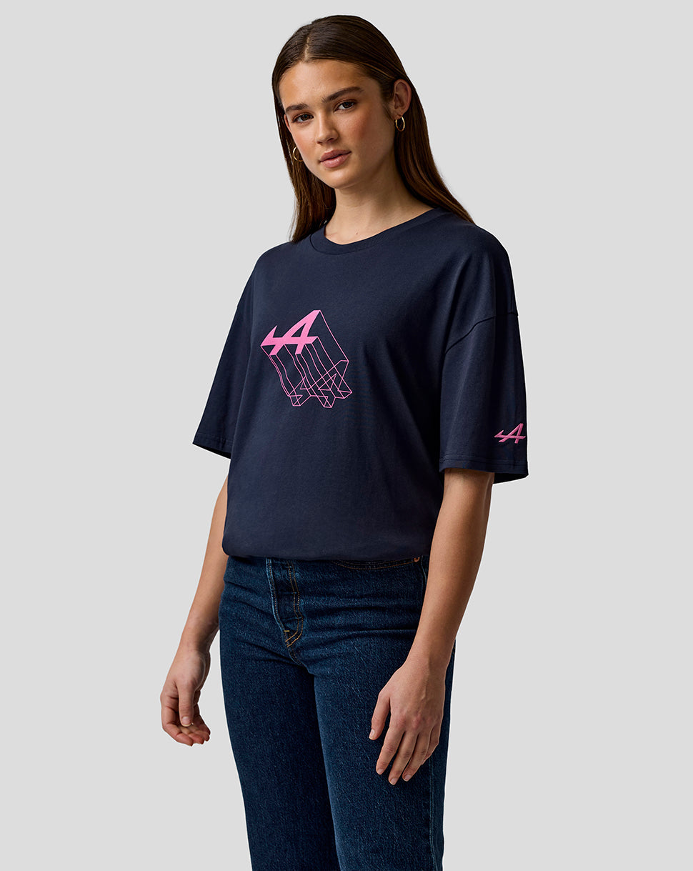 Woman wearing navy relaxed fit T-shirt with pink Alpine graphic on chest.