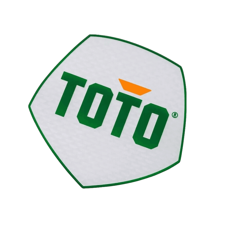 White Toto badge patch with green lettering and orange accent.