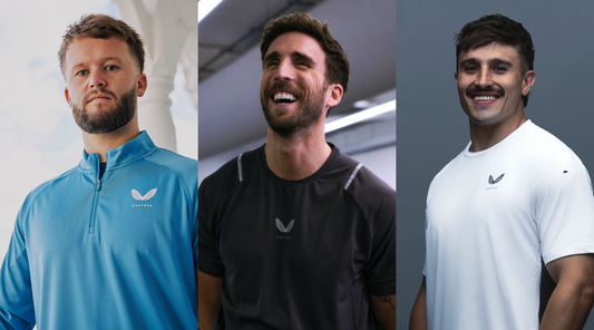 Three Castore ambassadors in blue, charcoal, and white athletic tops pose in a studio.