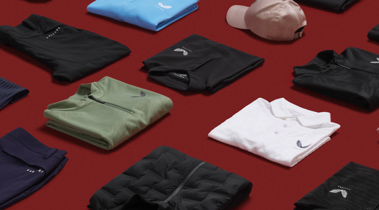 Castore clothing laid out on a red surface for the Christmas Gift Guide, including polo shirts and hats.