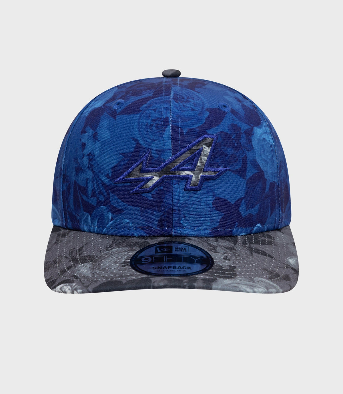 Blue floral New Era Alpine 9Fifty cap with gray camo brim and visible 9FIFTY sticker on the brim