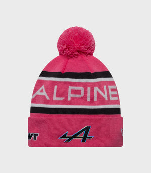 Pink knit cuff beanie with fluffy pom pom and Alpine branding on the cuff