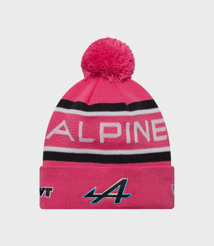 Pink cuff knit beanie with pom pom and Alpine branding on the folded brim