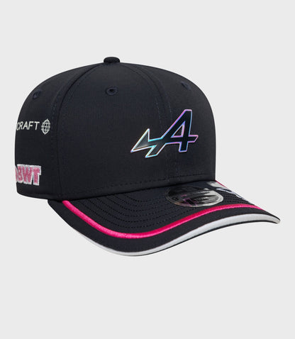 Front of navy cap with iridescent logo on crown pink piping along brim and sticker on brim