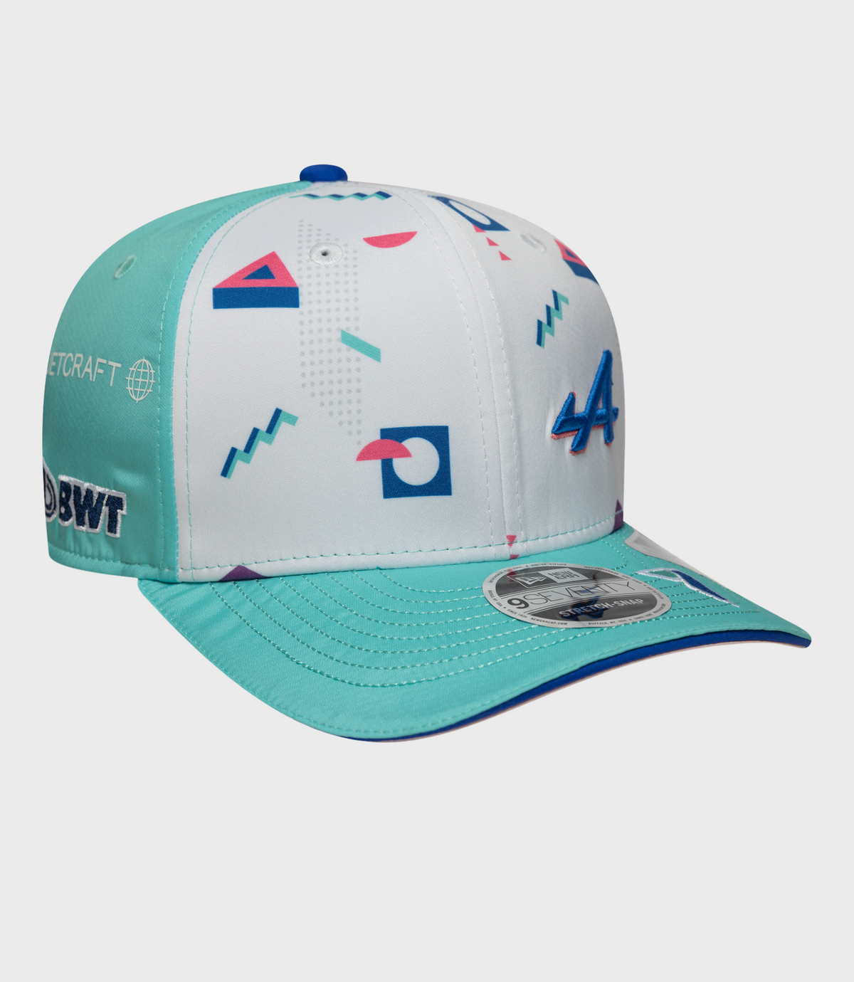Geometric teal and white cap with teal brim and a 9Seventy sticker visible on the brim.