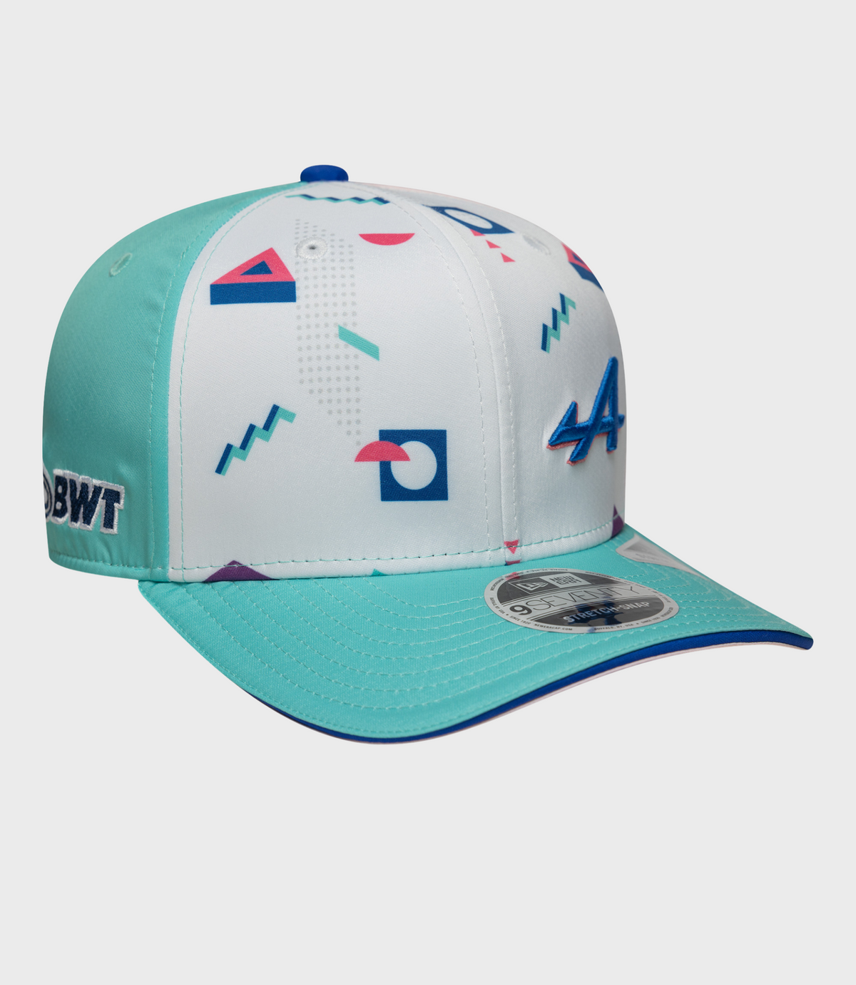 Close-up of white crown with colorful geometric prints and teal brim on a Miami 9Seventy cap